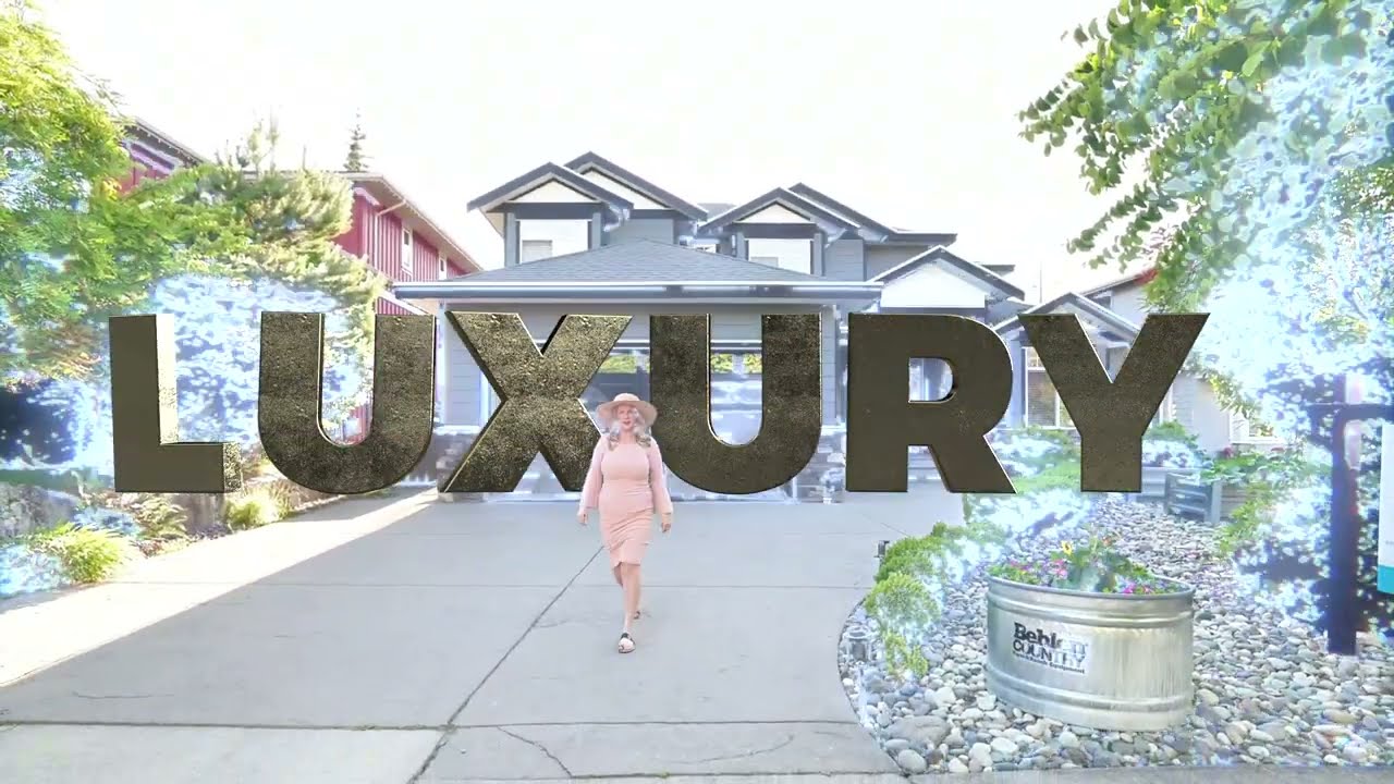 Real estate agent Em Smith walks on the driveway of a beautiful residential home with curb appeal on Jay Crescent in the Garibaldi Highlands in Squamish, BC.